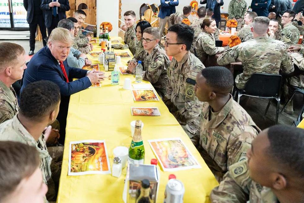 2019 photo of Donald Trump with troops