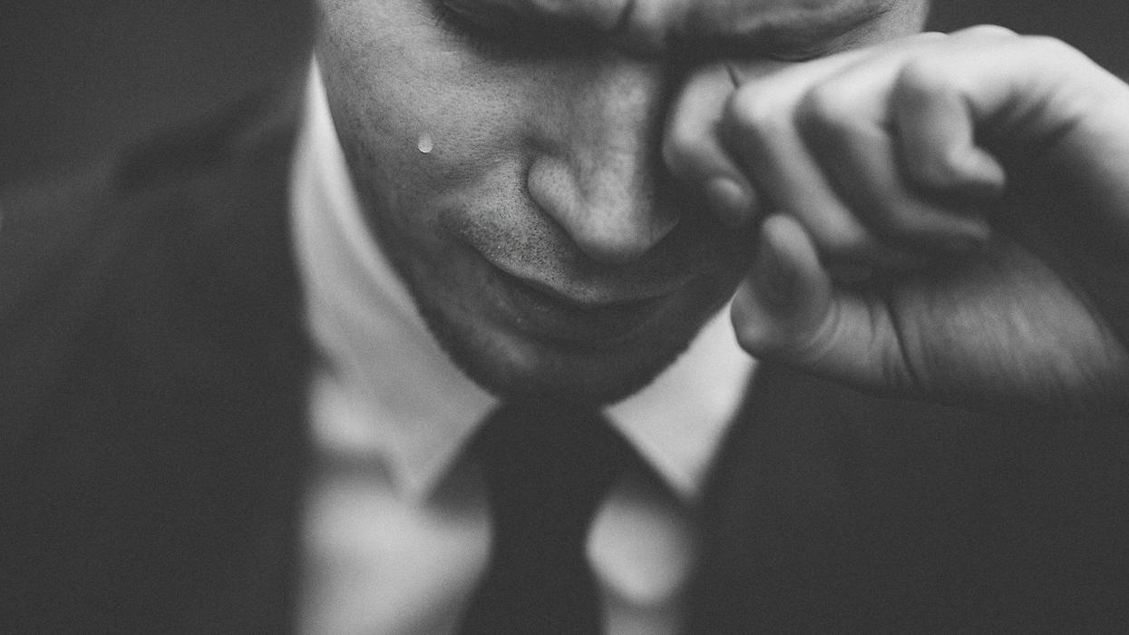 A black and white photo of a man crying