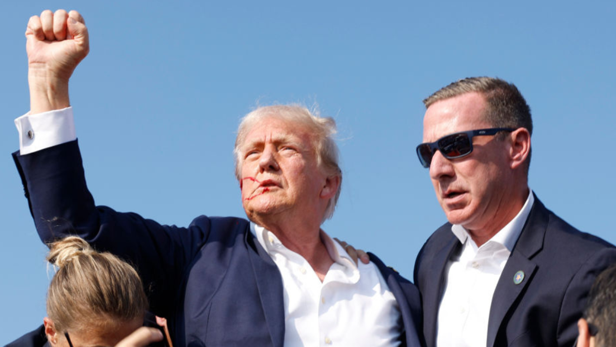 A bloodied Donald Trump raises his fist after surviving an assassination attempt