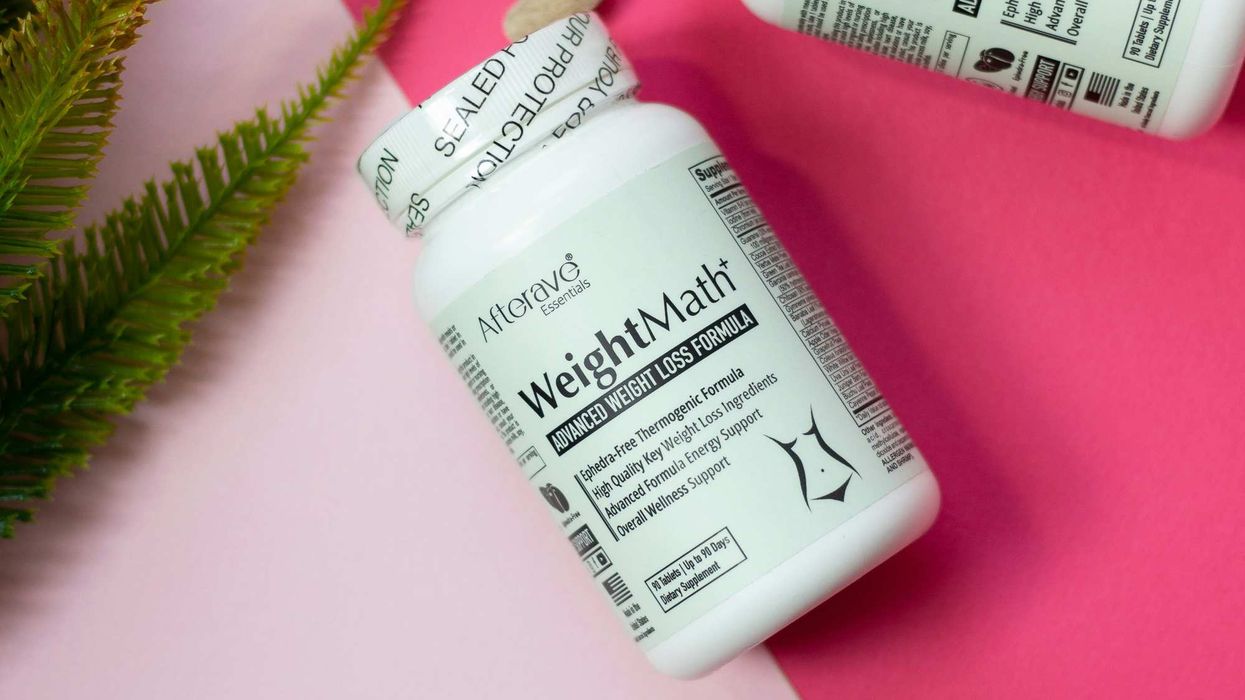 A bottle of vitamins with pills spilling out