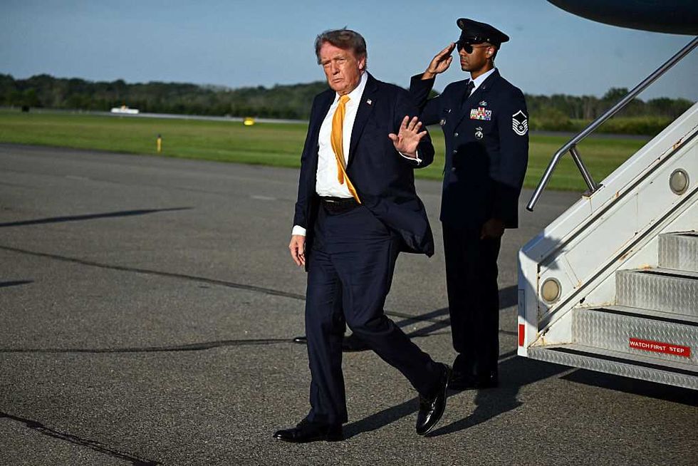 A brown-haired Donald Trump departing Air Force One