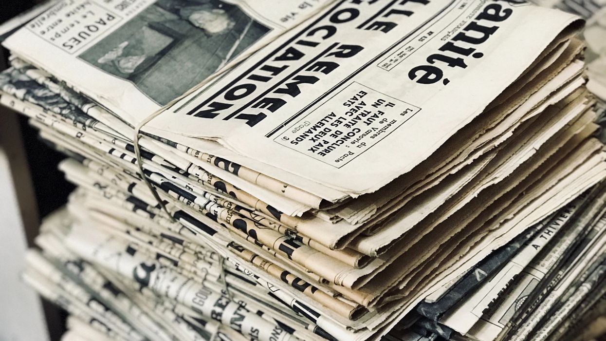 A bundle of old, yellowed newspapers