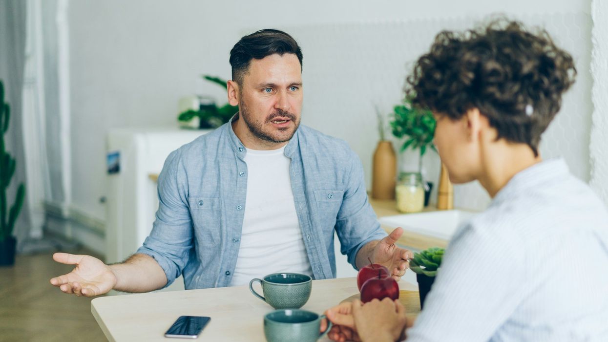 A couple argues in the kitchen.