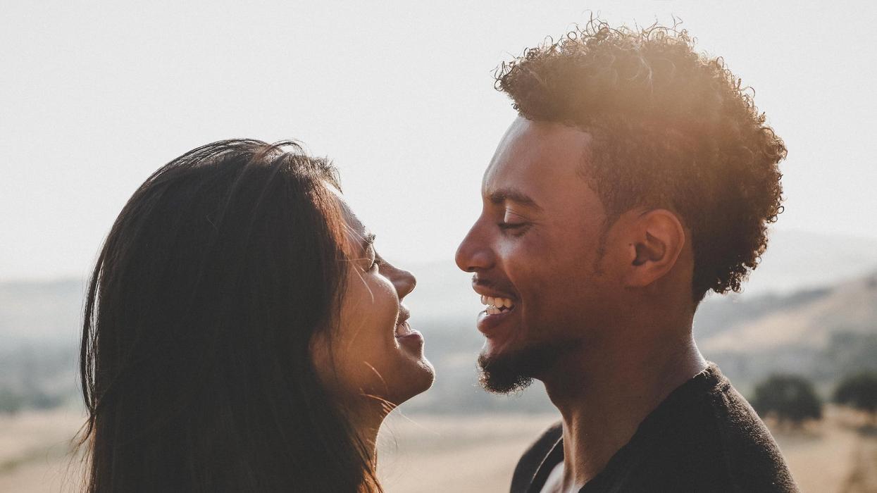 A couple smiles at one another lovingly
