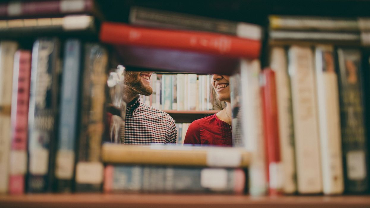 A couple smiling at each other in a library