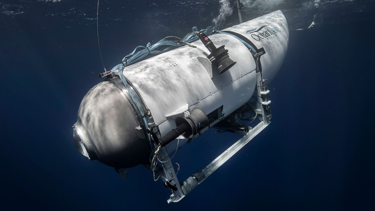 A file photo from OceanGate depicts the Titan submersible descending in the ocean