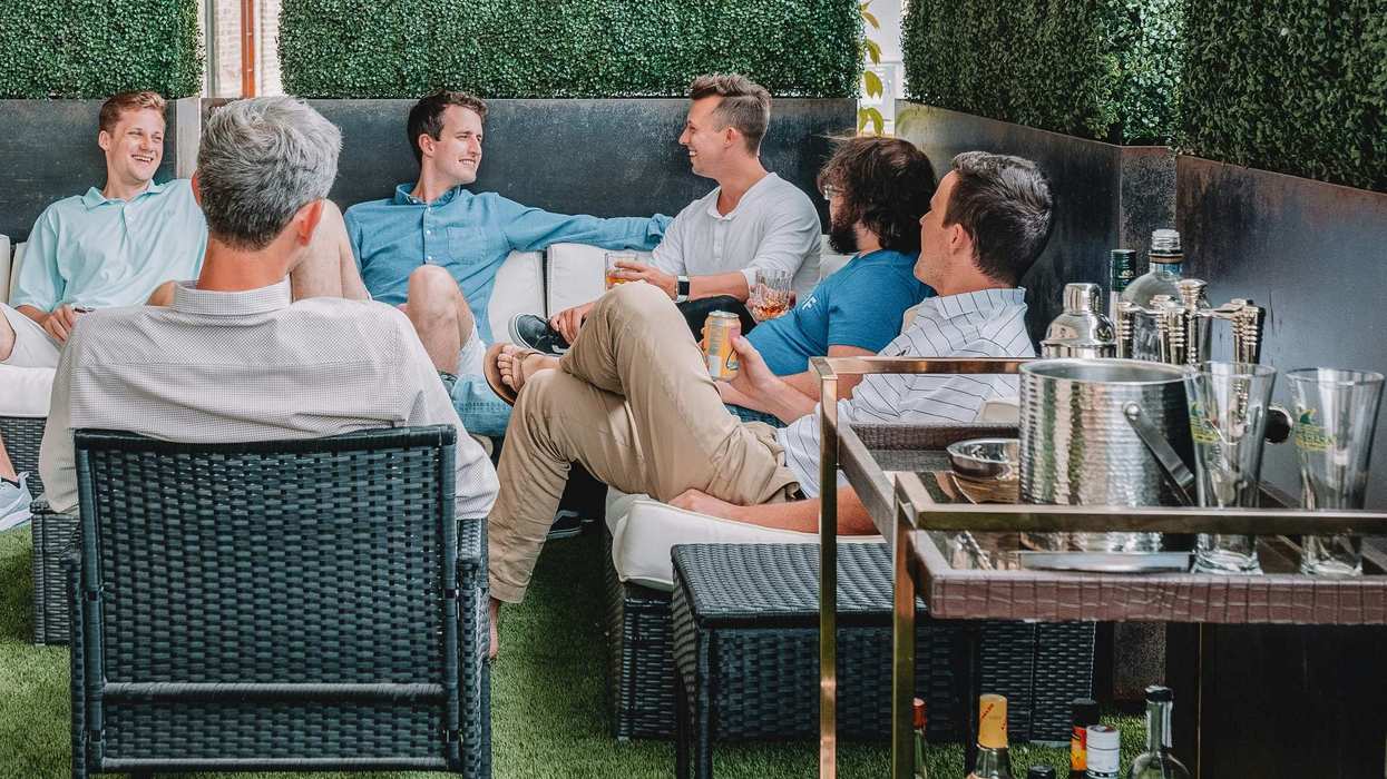 A group of men sitting on lawn furniture