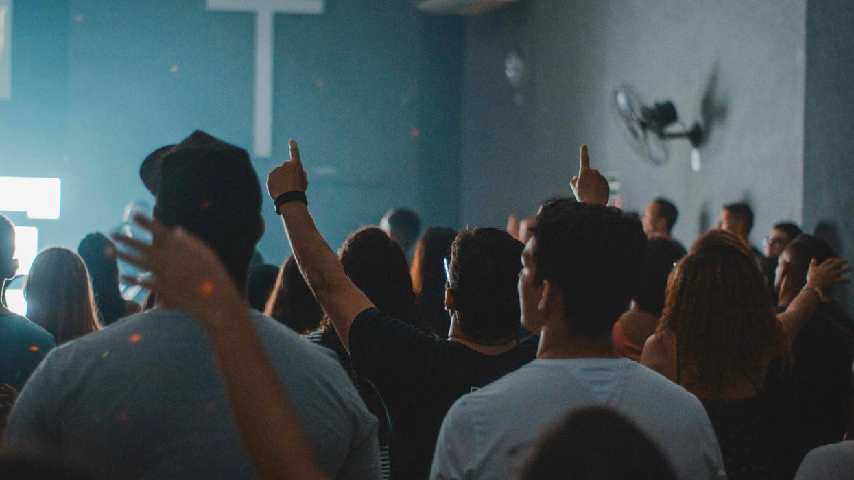 A Group of people in a a cult-like meeting