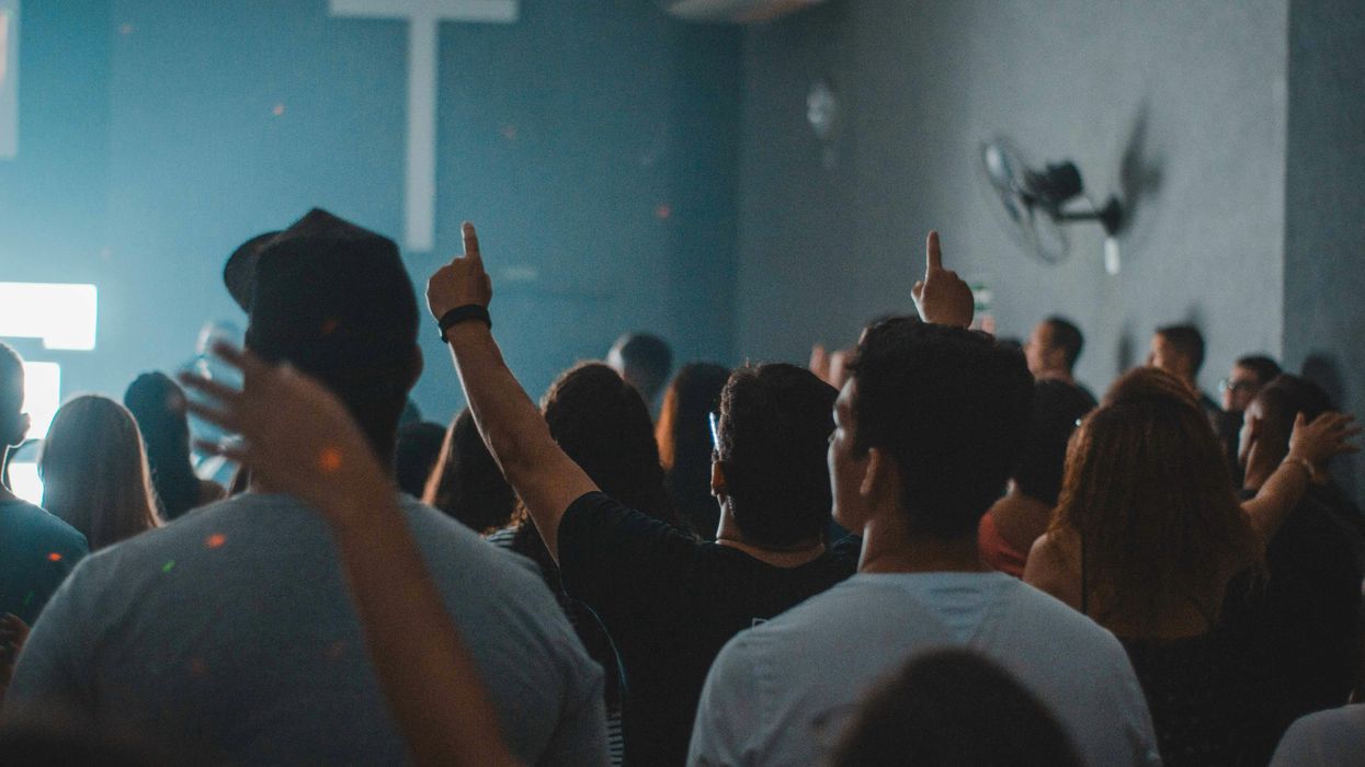 A Group of people in a a cult-like meeting