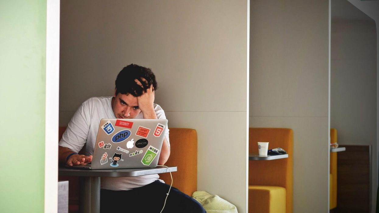 A man at a computer baffled by something