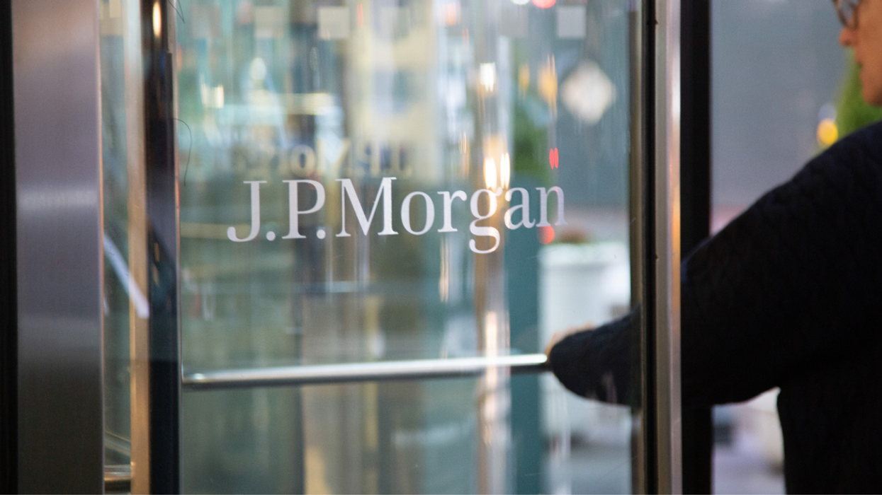 A man entering a glass J.P. Morgan door