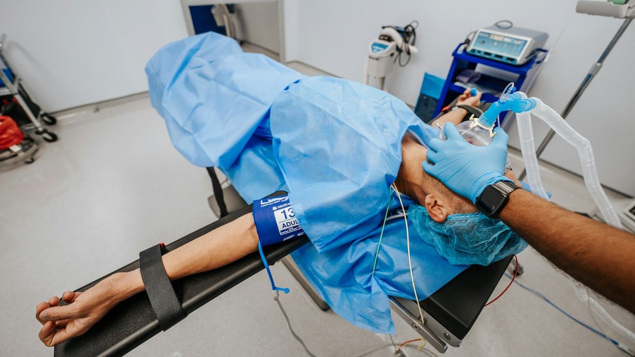 A man in distress is being attended to in the ER.