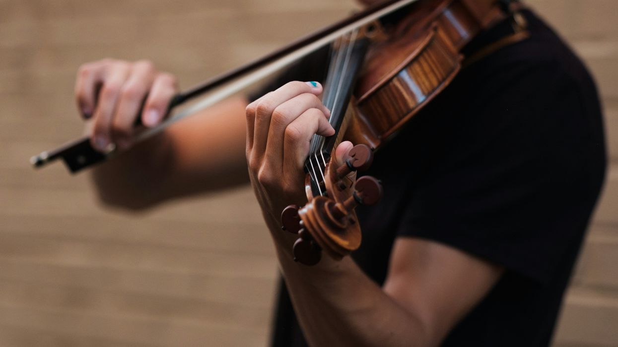 A Man Playing A Violin