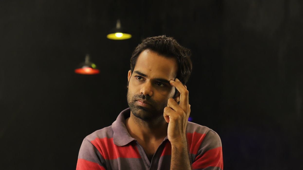 A man stares out, deep in thought