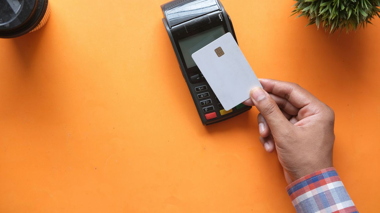 A man tapping his credit card on a machine