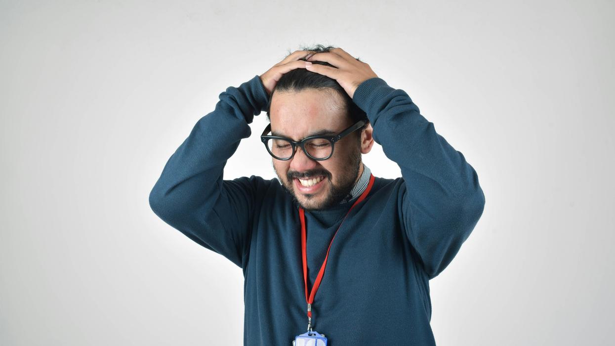 A man with his hands on his head