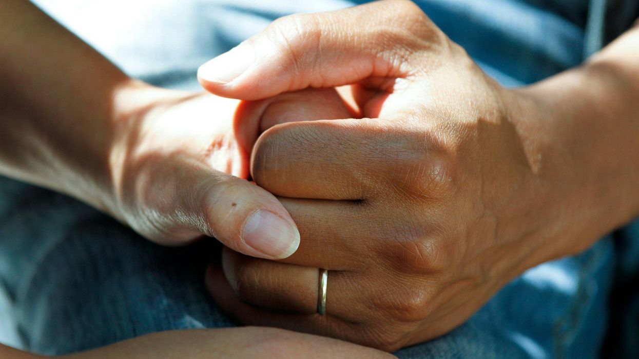 A pair of hands embrace