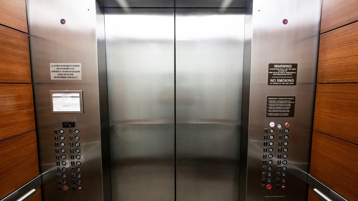 A photo of elevator doors and buttons from the inside of the elevator