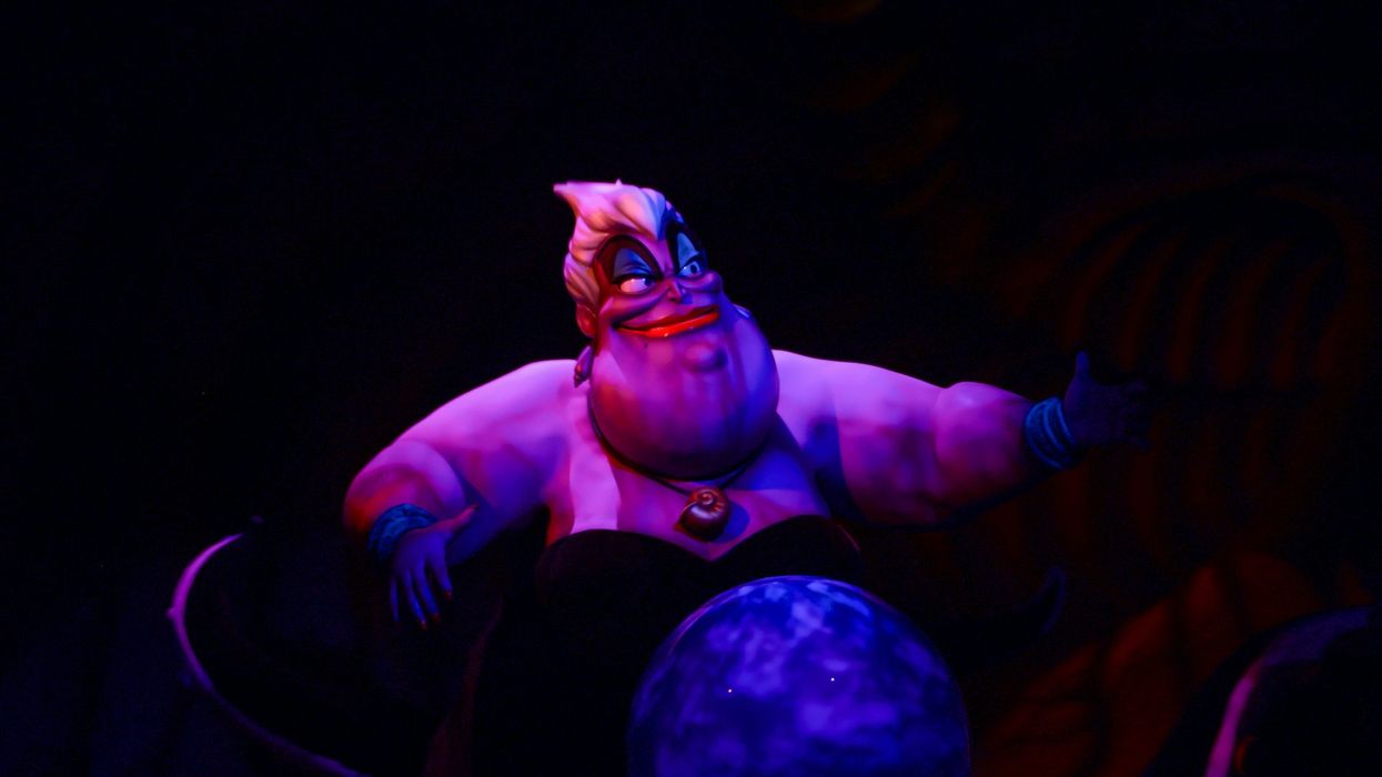 A photo of Ursula from "The Little Mermaid." She is smiling and floating against a black background.