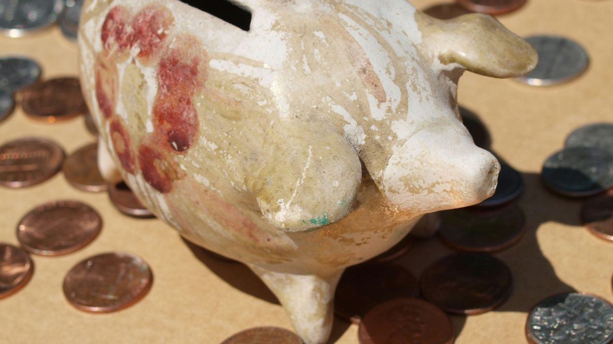 A piggy bank surrounded by loose change.