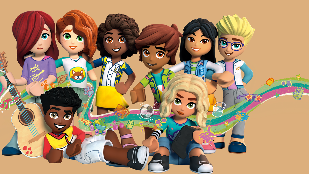 A racially diverse group of 8 LEGO characters are arranged as if posing for a picture, with 6 standing and 2 sitting down in front of the rest of the group.