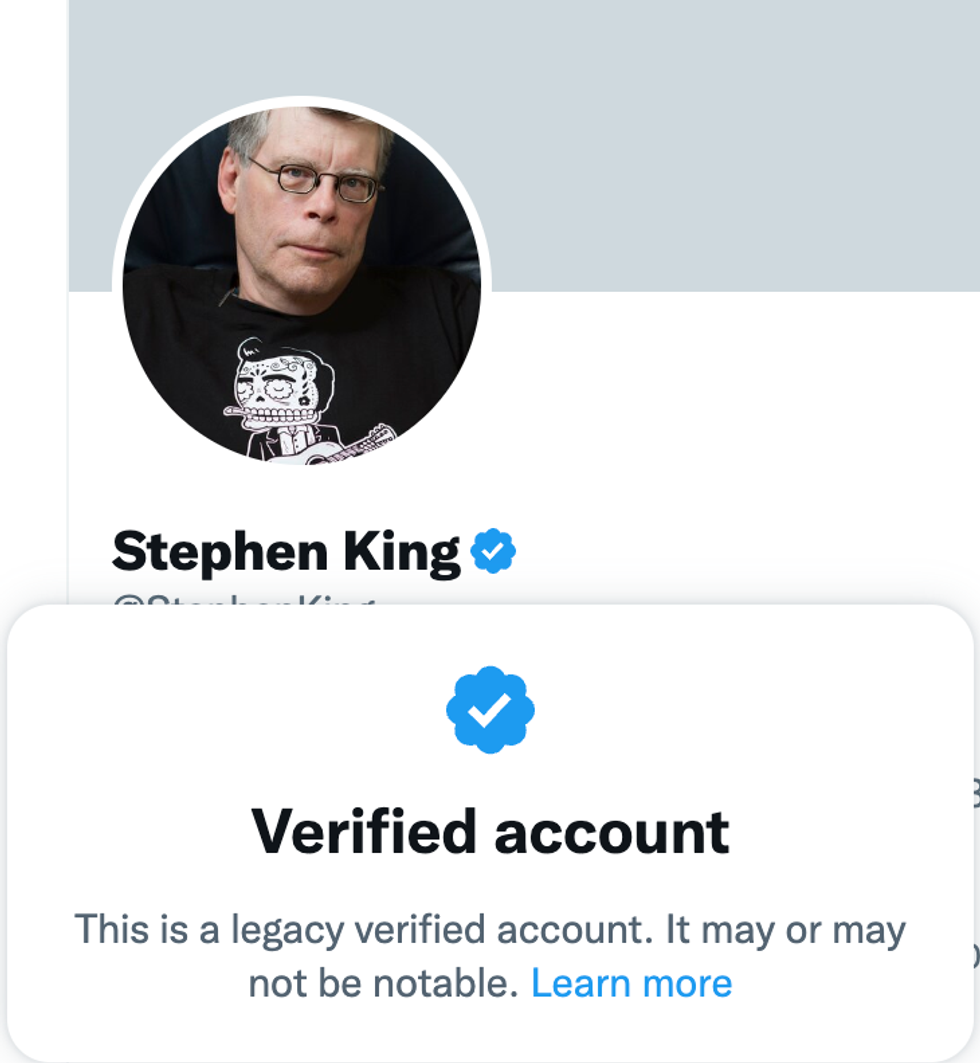 A screenshot of the profile of author Stephen King on Twitter with the text "Verified Account. This is a legacy verified account. It may or may not be notable. Learn more"