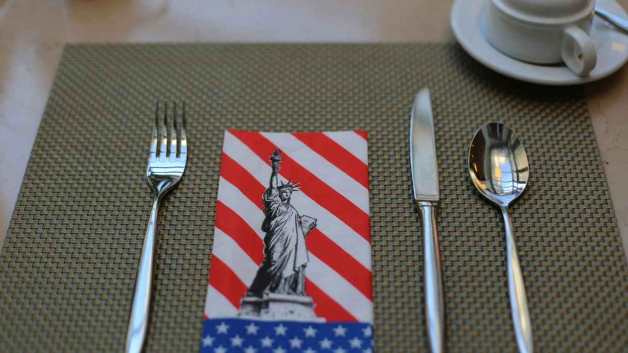 A table setting with a napkin of the American flag and the Statue of Liberty
