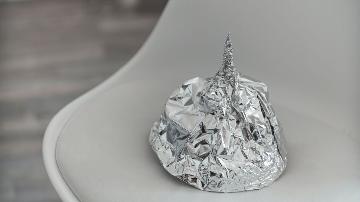 A tin foil hat resting on a chair