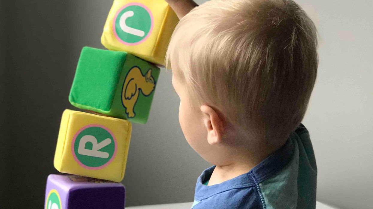 A toddler playing with his toys
