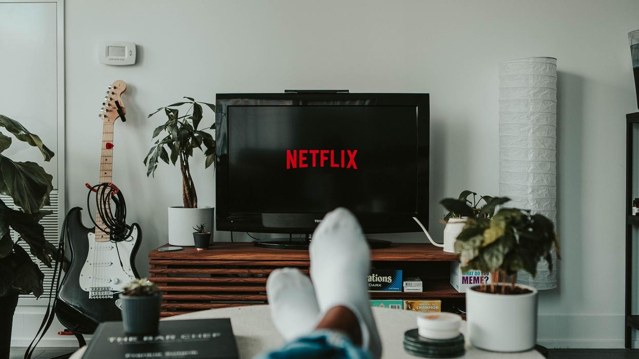 A viewer sitting in front of the TV