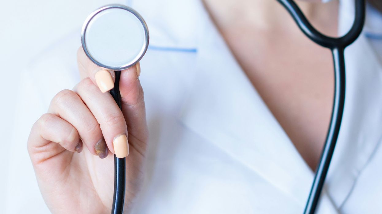 A woman holding a stethescope