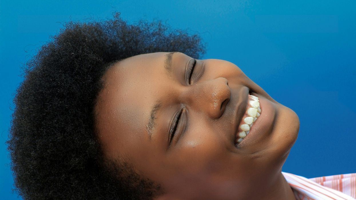 A woman leaning her head back and smiling