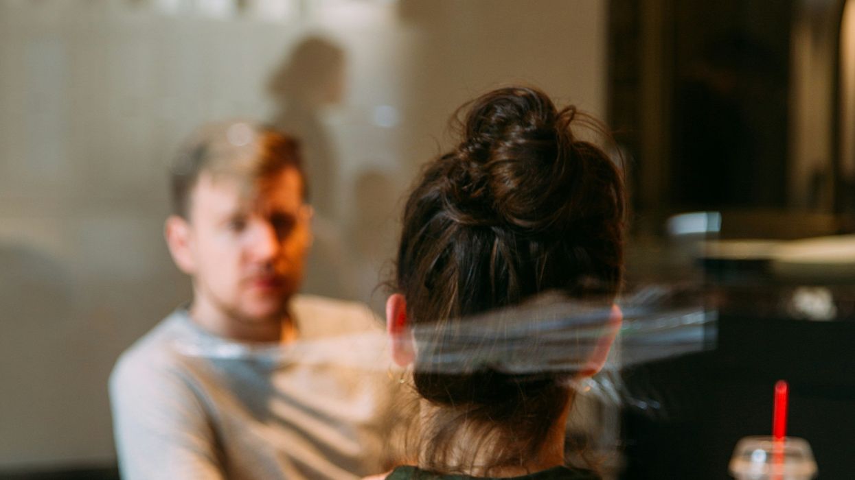 A woman talking to a man.