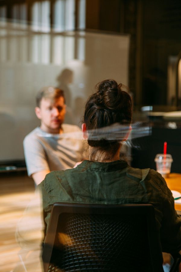 A woman talking to a man.