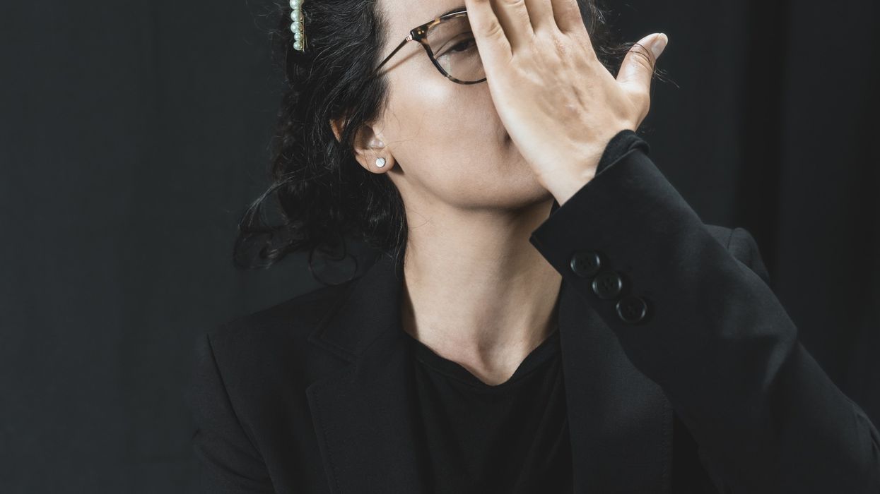 a woman with her hands on her face