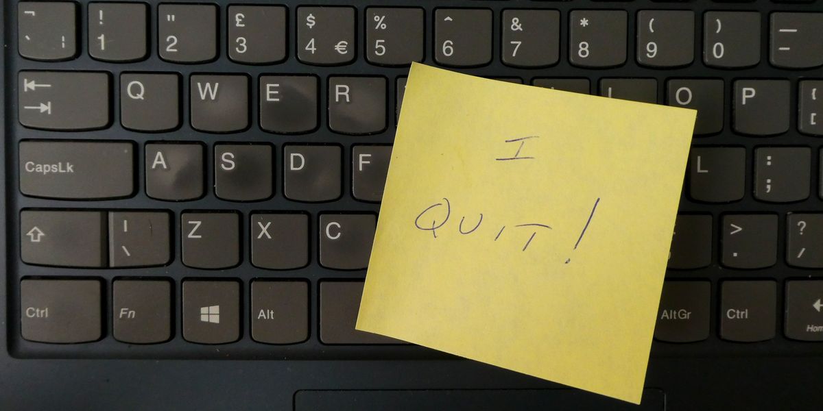 a yellow notepad on a keyboard