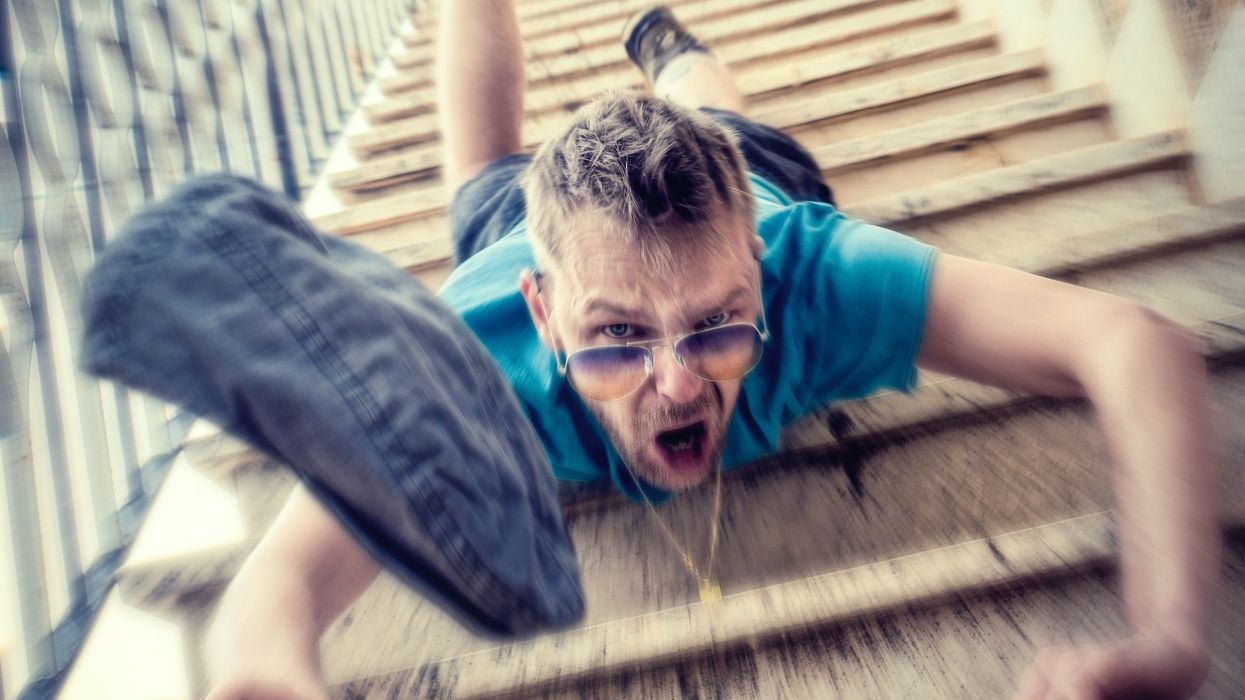 A young party boy falls down the stairs