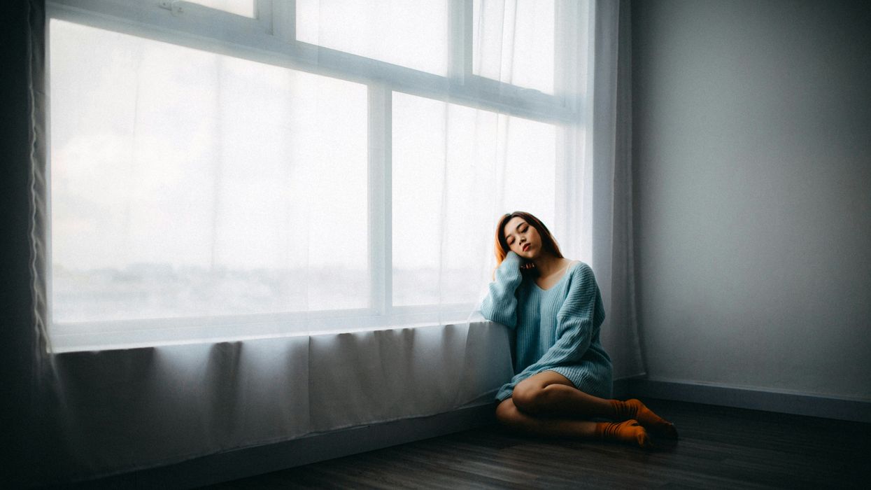 A young woman leaning against the window