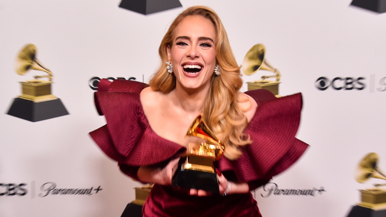 Adele holding a Grammy Award