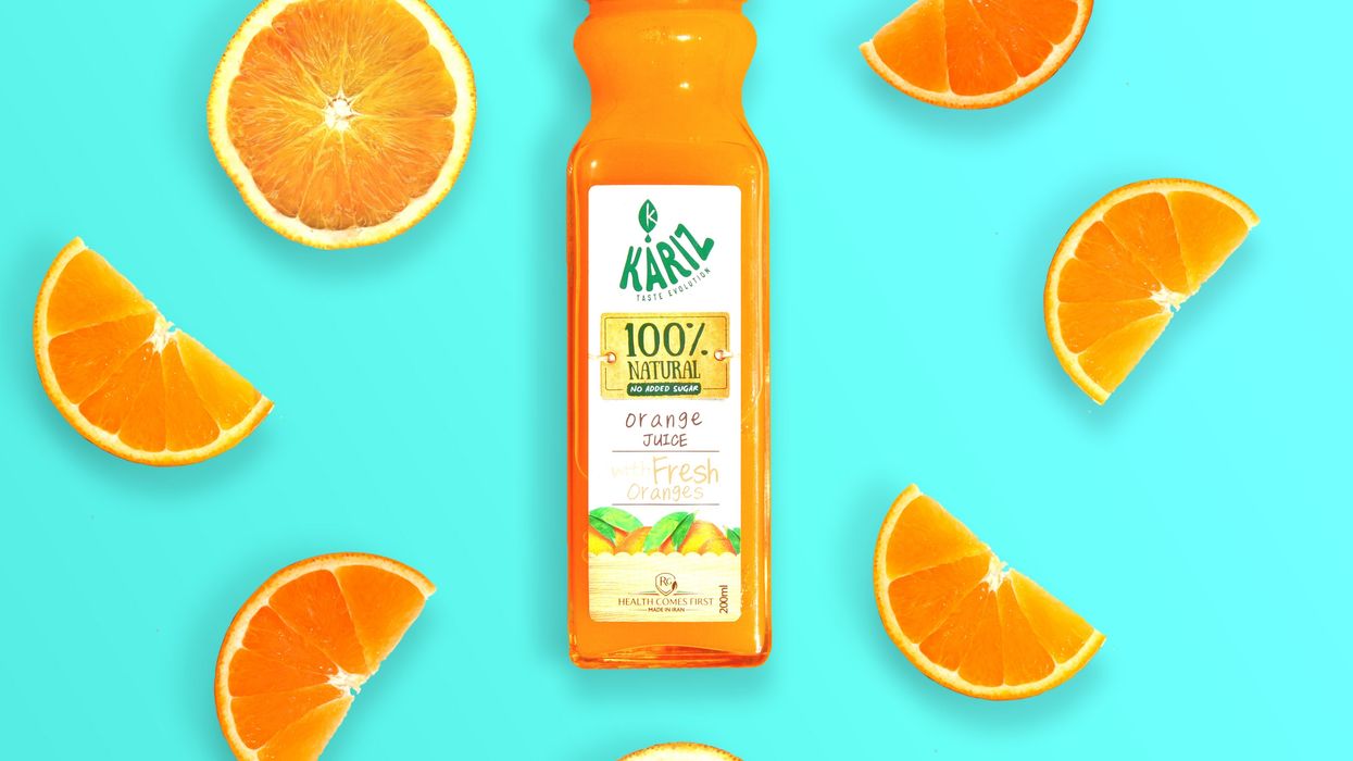 Advertisement for orange juice with blue background and orange slices