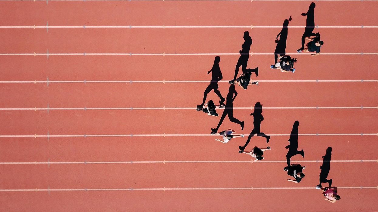 An arial shot of a group of runners on red clay.