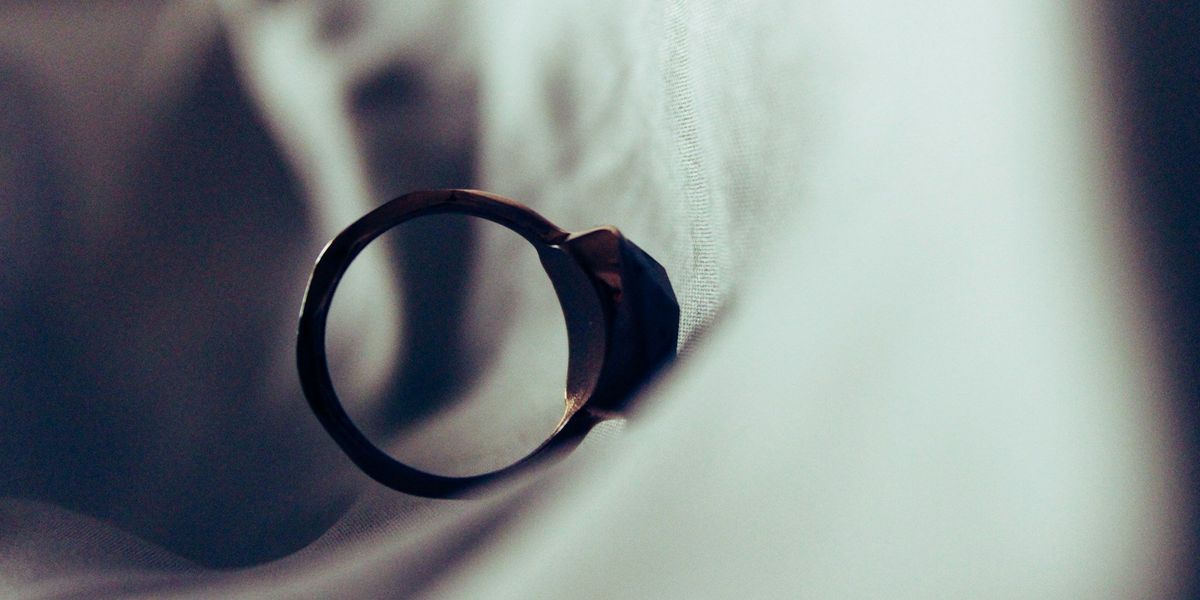 An engagement ring falls down a sheet