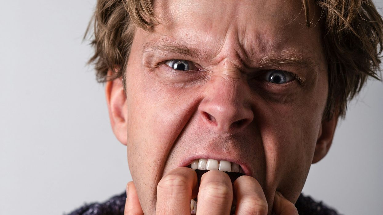 angry man in blue and white long sleeve shirt