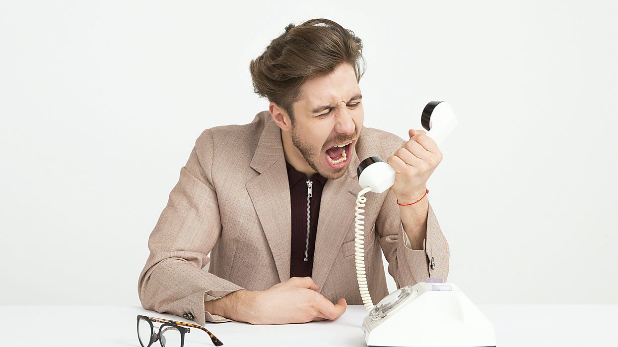 Angry man yelling into a phone