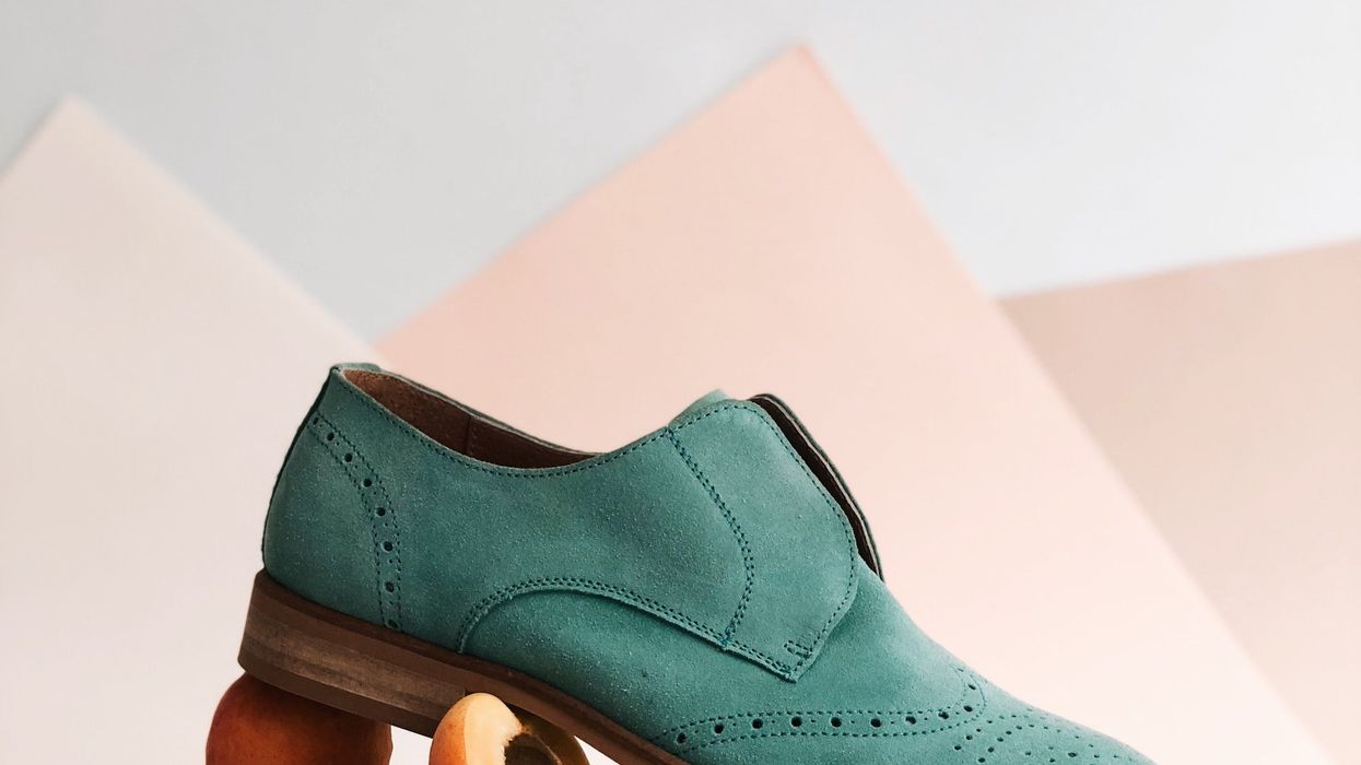 aquamarine shoe is placed on top of sliced peaches