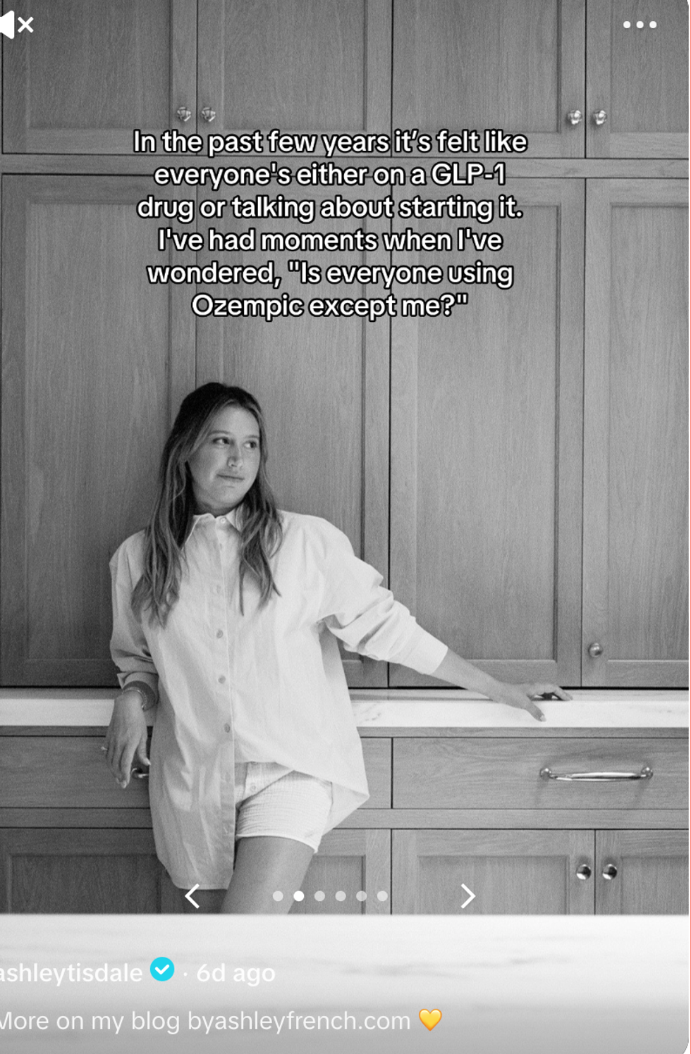 Ashley Tisdale in black and white in front of cabinets