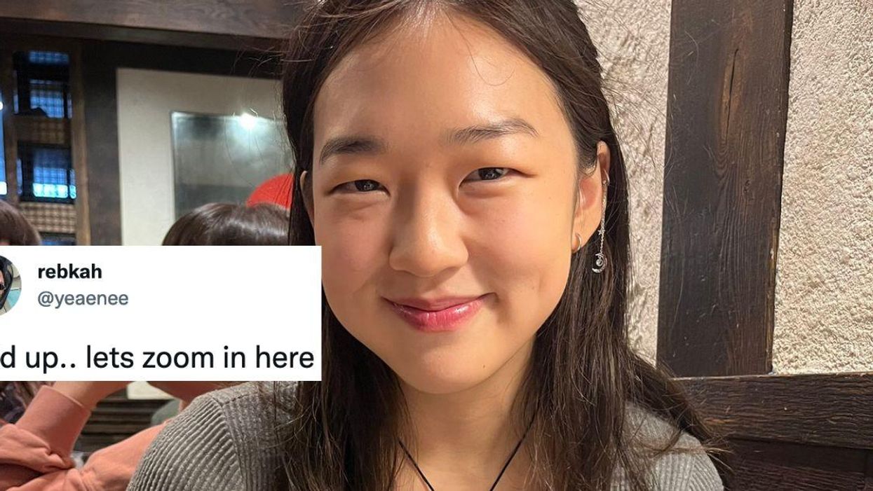 Asian woman; her tweet, which reads, "hold up..lets zoom in here."