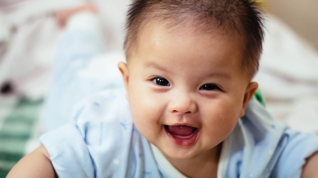 baby smiling and lying forward