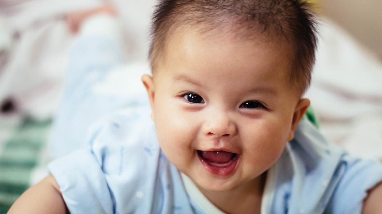 baby smiling and lying forward