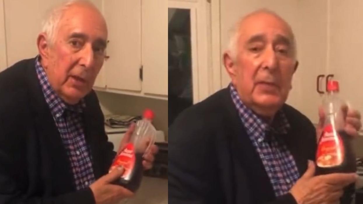 Ben Stein holding a syrup bottle